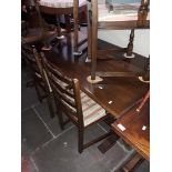 An oak dining table with carved bulbous legs and 6 ladder back chairs