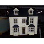 A dolls house with wooden furniture