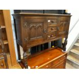 An oak reproduction sideboard with 3 central drawers