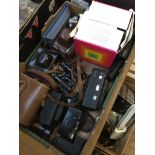 A box of various cameras and binoculars