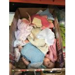 A box of dolls clothes and parts