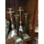 Two pairs of metal candlesticks