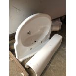 A ceramic pedestal bathroom sink