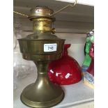 Brass and red glass oil lamp