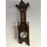 A Gothic style carved oak aneroid barometer, the dial inscribed 'J Franks Manchester'.