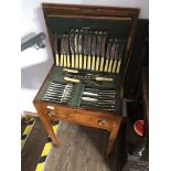 A 1930s oak canteen of silver plated cutlery.