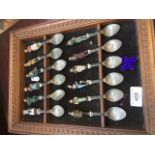 A display of souvenir spoons.