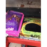 A boxed Barbie doll and a chess set