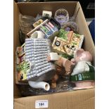 A box with two Wade money pigs, village collection teapots and scented candles