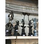 Four spelter figures and a plaster figure