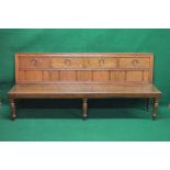 Walnut hall bench having panelled back with carved and reeded decoration over solid seat,