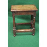 Oak joint stool having rectangular top supported on stretchered turned columns leading to bun feet