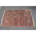 Red ground rug having white and blue pattern - 65" x 40.