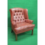 Late 20th century red leather button and wing back armchair having wide seat with removable seat