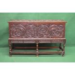 19th century oak coffer on stand having heavily carved decoration the top lifting to reveal storage