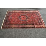 Red ground rug having black, red and white pattern - 82" x 51.