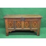 Oak coffer the top lifting to reveal storage space and having four panelled front with inlaid