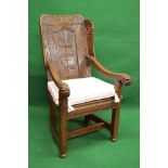 Oak carved panelled back wing armchair the back being carved with the date 1633 and supported by