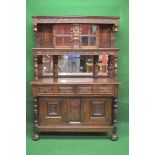 Oak carved dresser having glazed upper section of two doors opening to reveal single fixed shelf