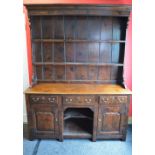 Late 20th century oak Georgian style canopy topped dresser having two shelved plate rack over a