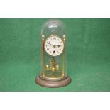 Brass Anniversary clock under glass dome having black numeral dial with black hands and single