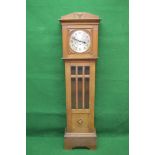 Oak cased Grandmother clock having silvered dial with black numerals and hands and three winding