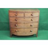 Mahogany bow fronted chest of drawers having two short and three long graduated drawers with turned