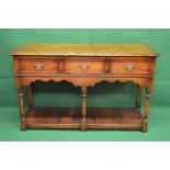 Oak three drawer serving table/sideboard having three short drawers over shaped frieze,