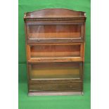 Oak sectional glazed bookcase having raised gallery and three up and over glazed doors with knob