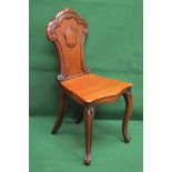 Victorian mahogany hall chair having shaped back with shield motif over solid seat,