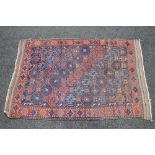 Blue ground rug having red and brown decoration - 74" x 49.