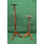 Two mahogany torcheres each having circular top supported by twist column leading to cabriole