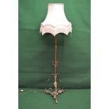 Victorian brass standard lamp with shade having central column with scrolled foliate supports,