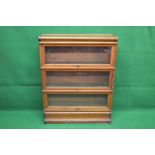 Oak three section Globe Wernicke bookcase having glazed up and over doors with metal knob handles