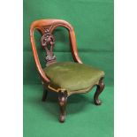 Mahogany nursing chair having hooped back with pierced back splat above over stuffed seat with