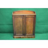 Victorian mahogany two door cabinet having 3/4 raised gallery over two panelled doors opening to