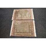 Pair of cream ground rugs having red,