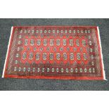 Red ground rug with blue and cream pattern and end tassels - 63.5" x 37.