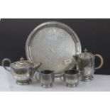 Four piece Tudric hammered pewter tea set with a similar hammered pewter tray