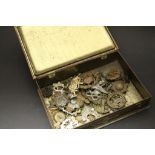 Tin of military cap badges