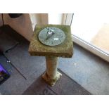Small stone pillar with copper Sun dial to top