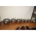 Set of Seven Copper Graduating Saucepans with Brass Handles