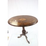 19th century Walnut oval topped tilt top table with inlaid decoration raised on pierced column and