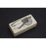 A bone snuff box decorated with scrimshaw cannon ,musket and sword to lid.