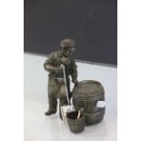 Spelter model of a man opening a barrel