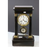 French gilt & black Wooden clock with enamel dial & key & supported on four columns, marked to