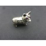 Cast silver figure of a dog with Emerald collar and Ruby eyes