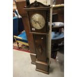An oak cased grand daughter clock with two train movement.