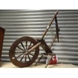 An antique spinning wheel for repair.