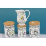 Three Portmeirion cannisters with wooden lids and a small jug all in Variations pattern